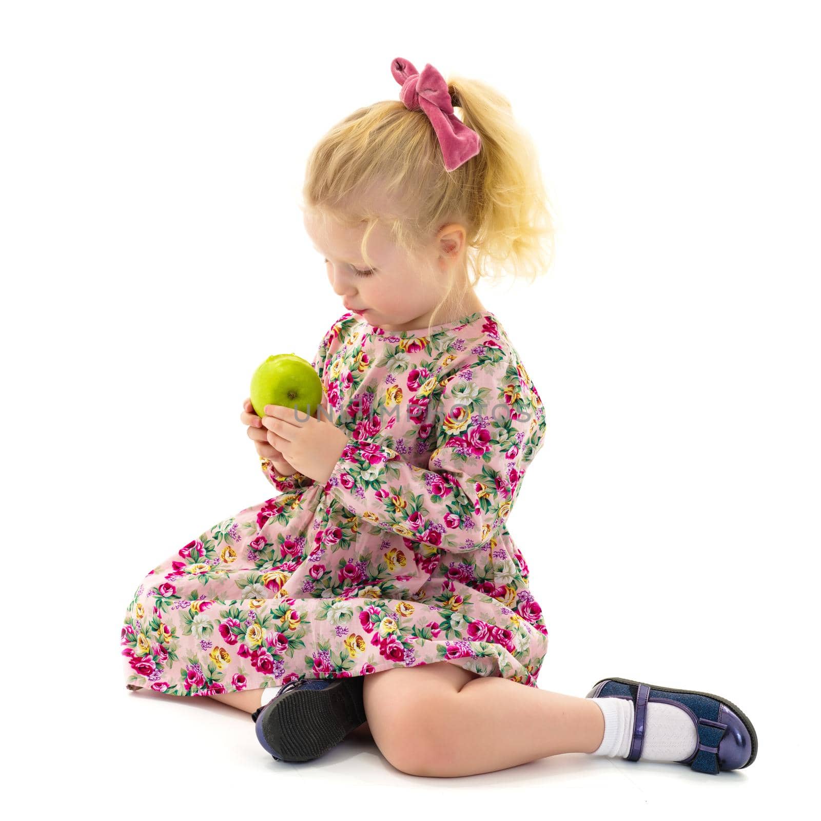 Little girl with an apple. Concept of healthy eating, harvesting. Isolated on white background.