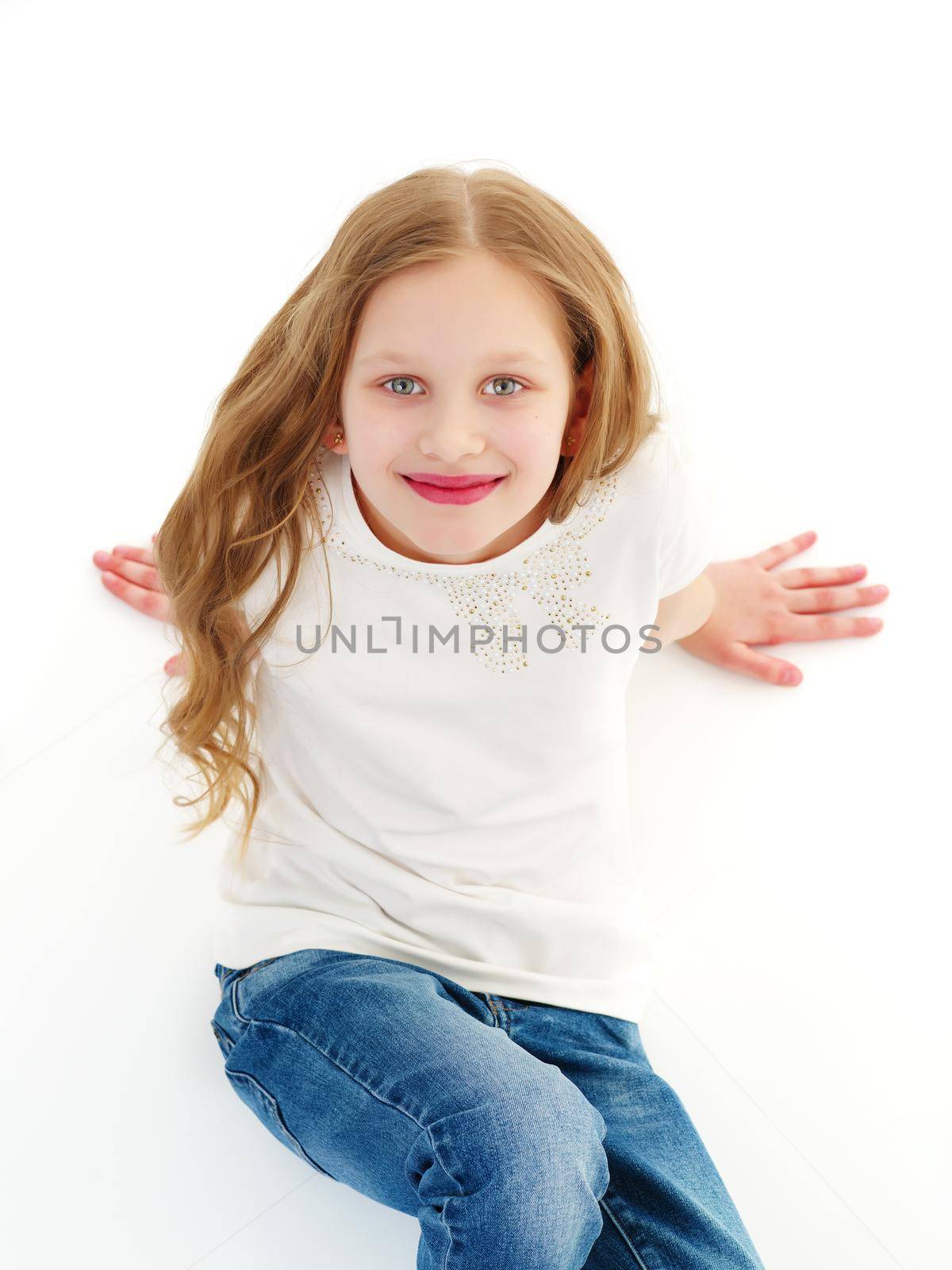 Portrait of a beautiful little girl looking from above. The concept of happy people, childhood. Isolated on white background. Close-up.