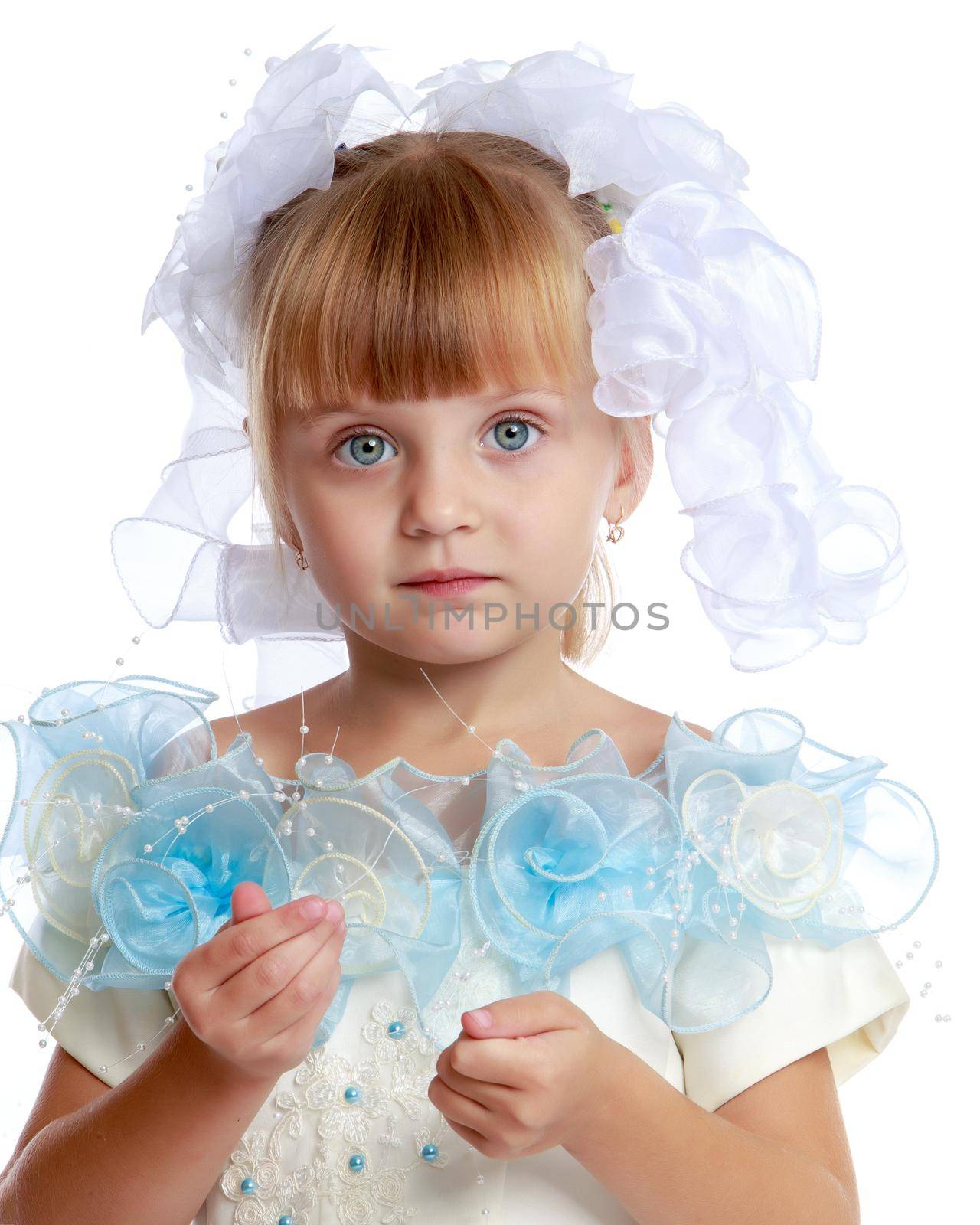 Charming little girl princess in a beautiful dress. The concept of a happy childhood, holidays. Close-up. Isolated on white.