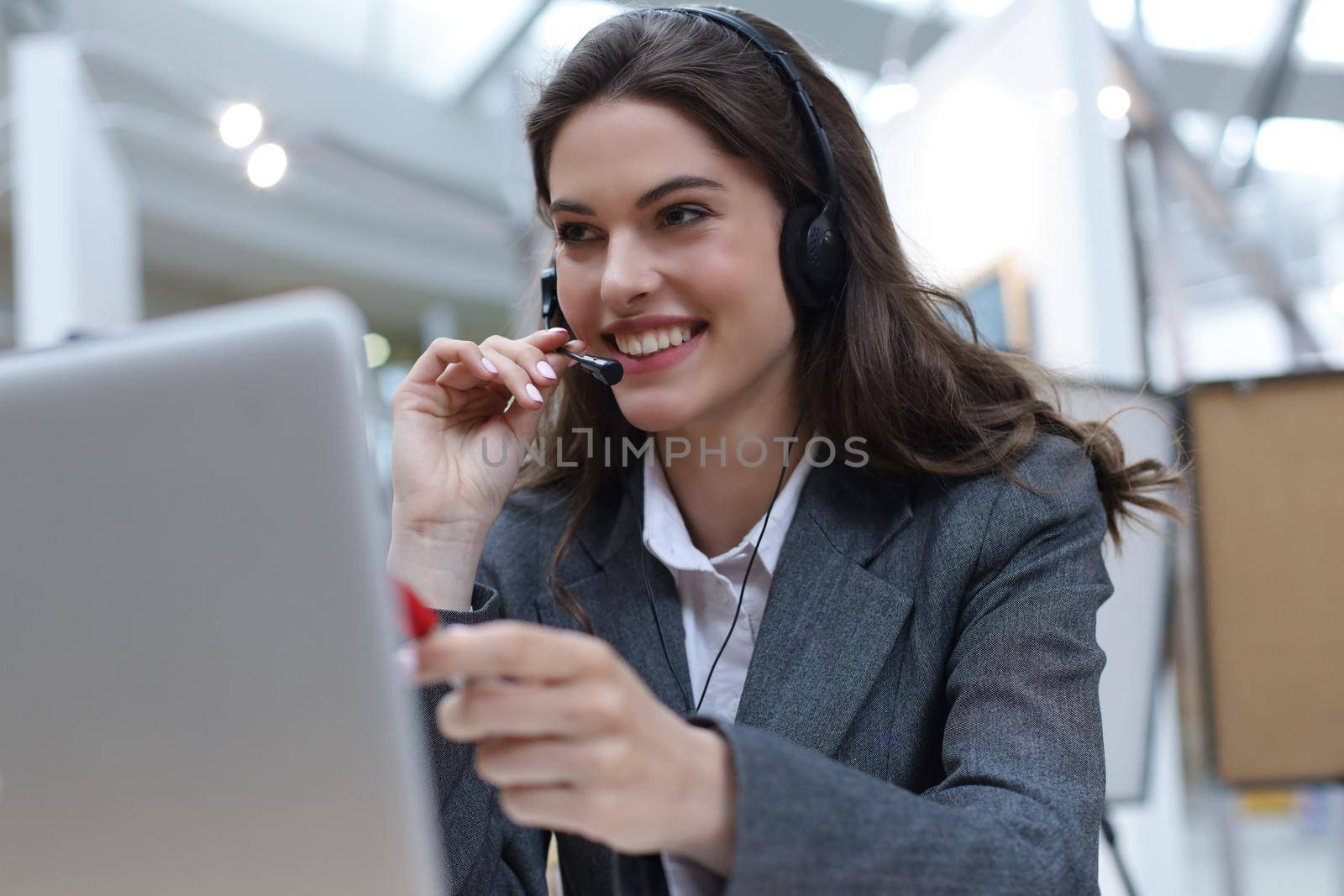Woman customer support operator with headset and smiling