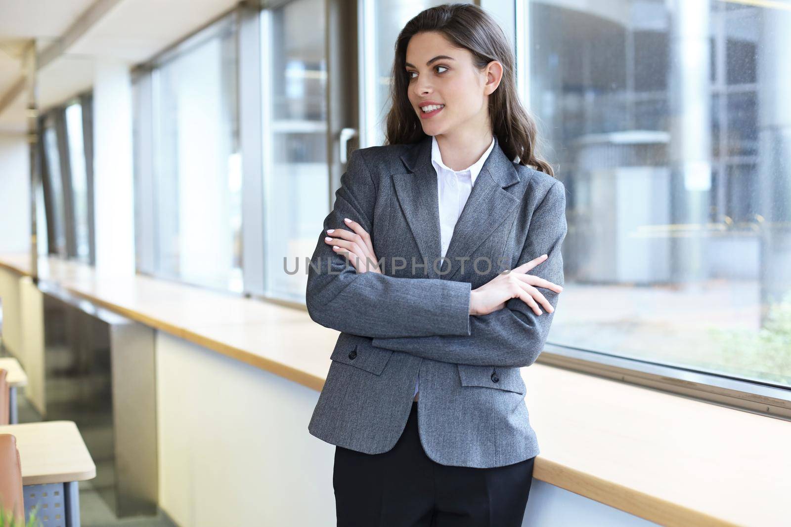 Attractive businesswoman standing near desk in the office