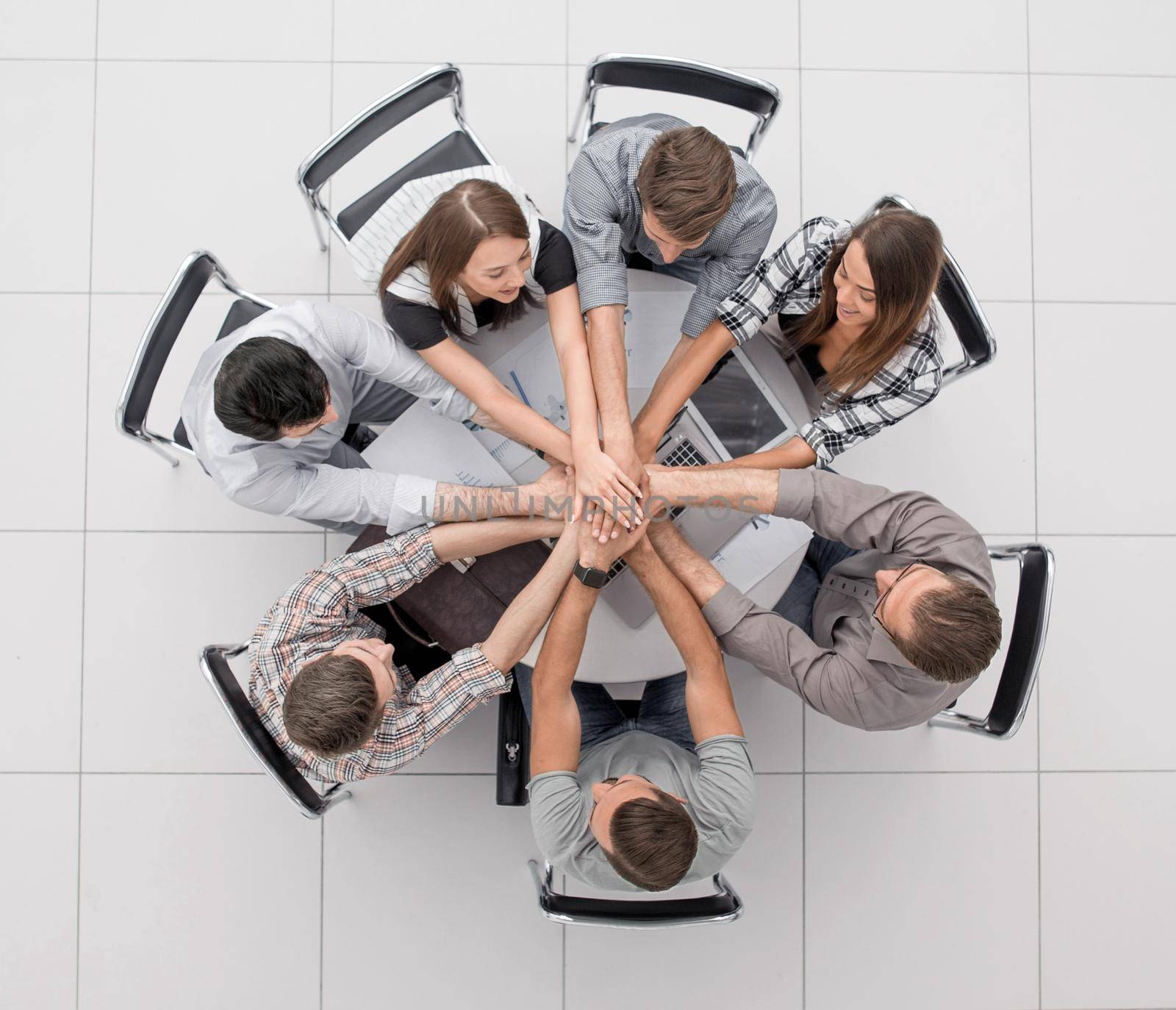 top view.successful business team by folding their hands togethe by asdf