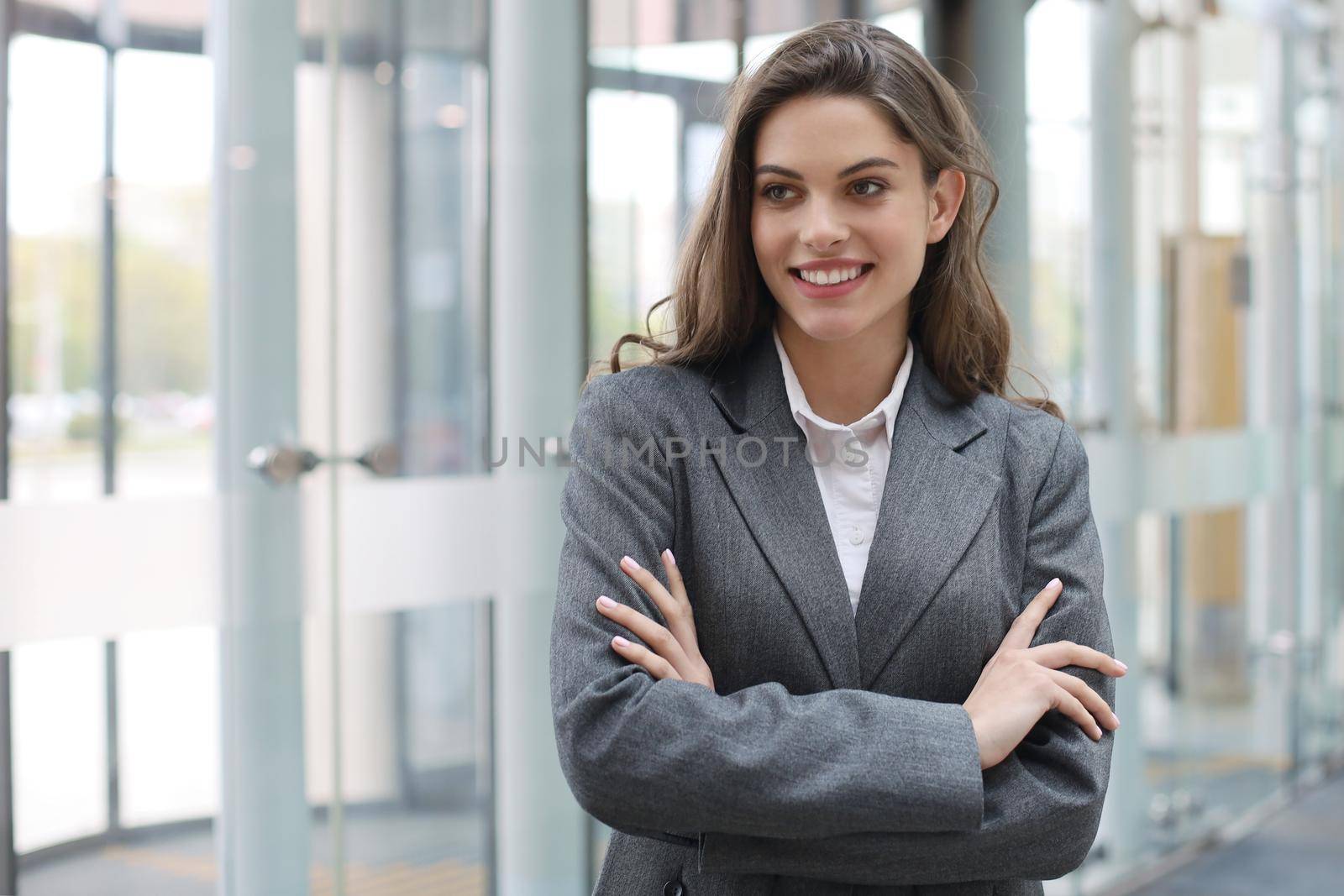 Attractive businesswoman standing near desk in the office