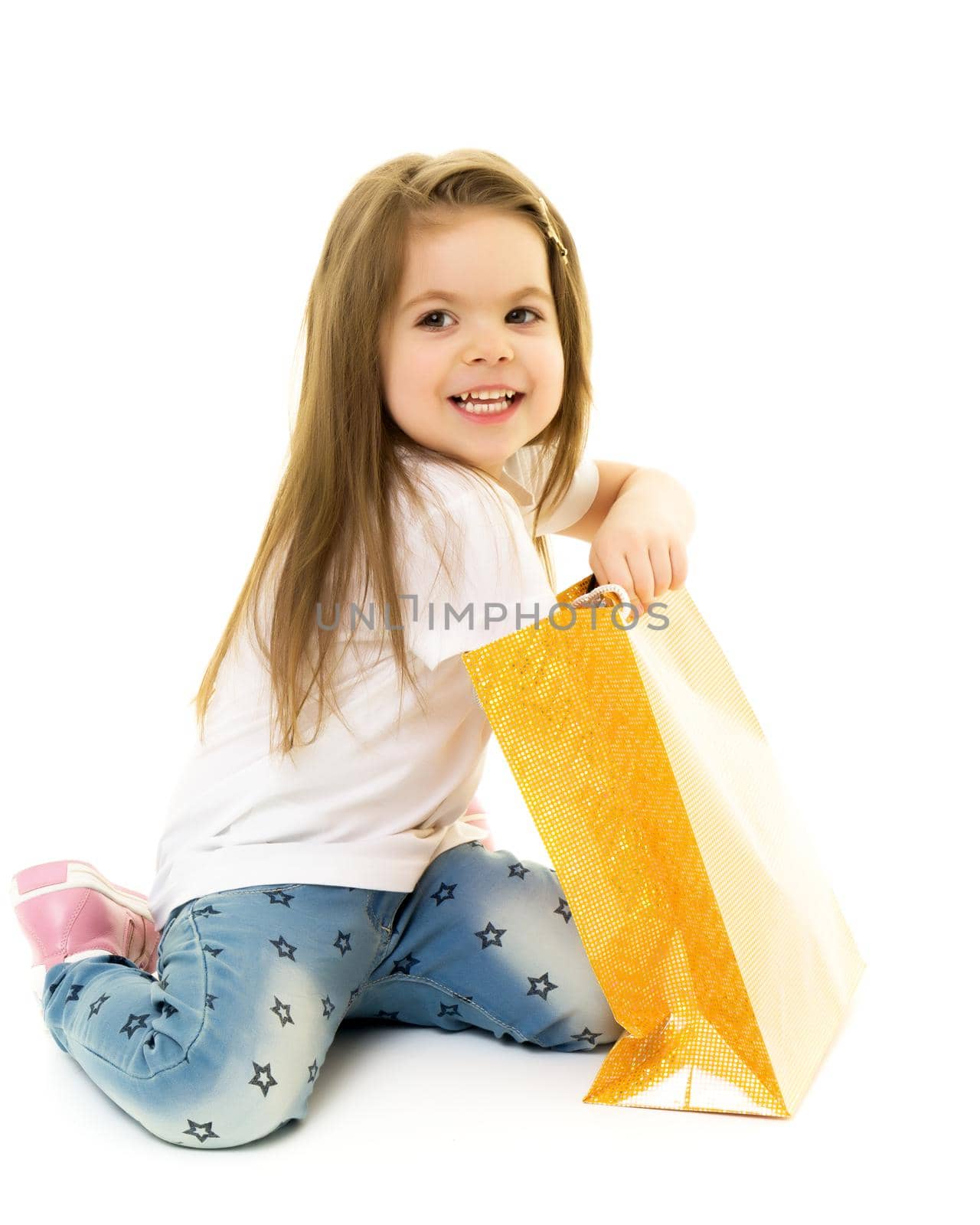 Cheerful preschool girl walks with bags. Shopping autumn-winter season. Shopping on Black Friday. Trading concept. Autumn sale season. Sale and discounts. Isolated on white background.