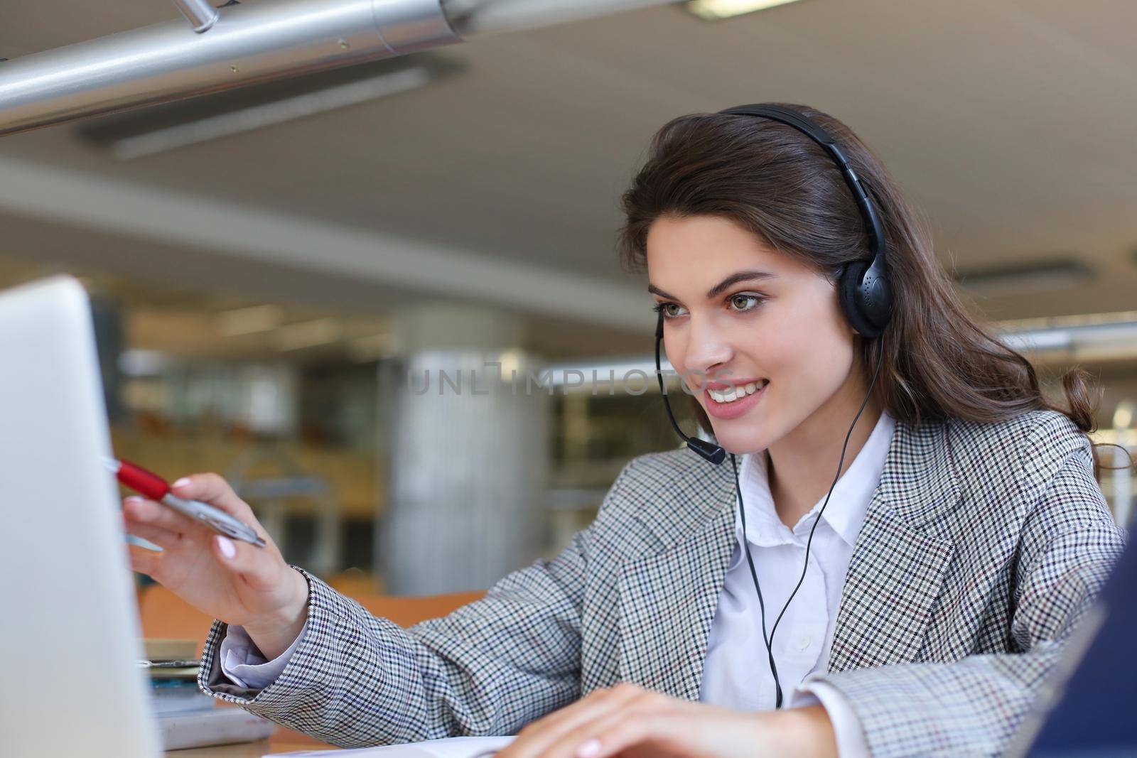 Woman customer support operator with headset and smiling
