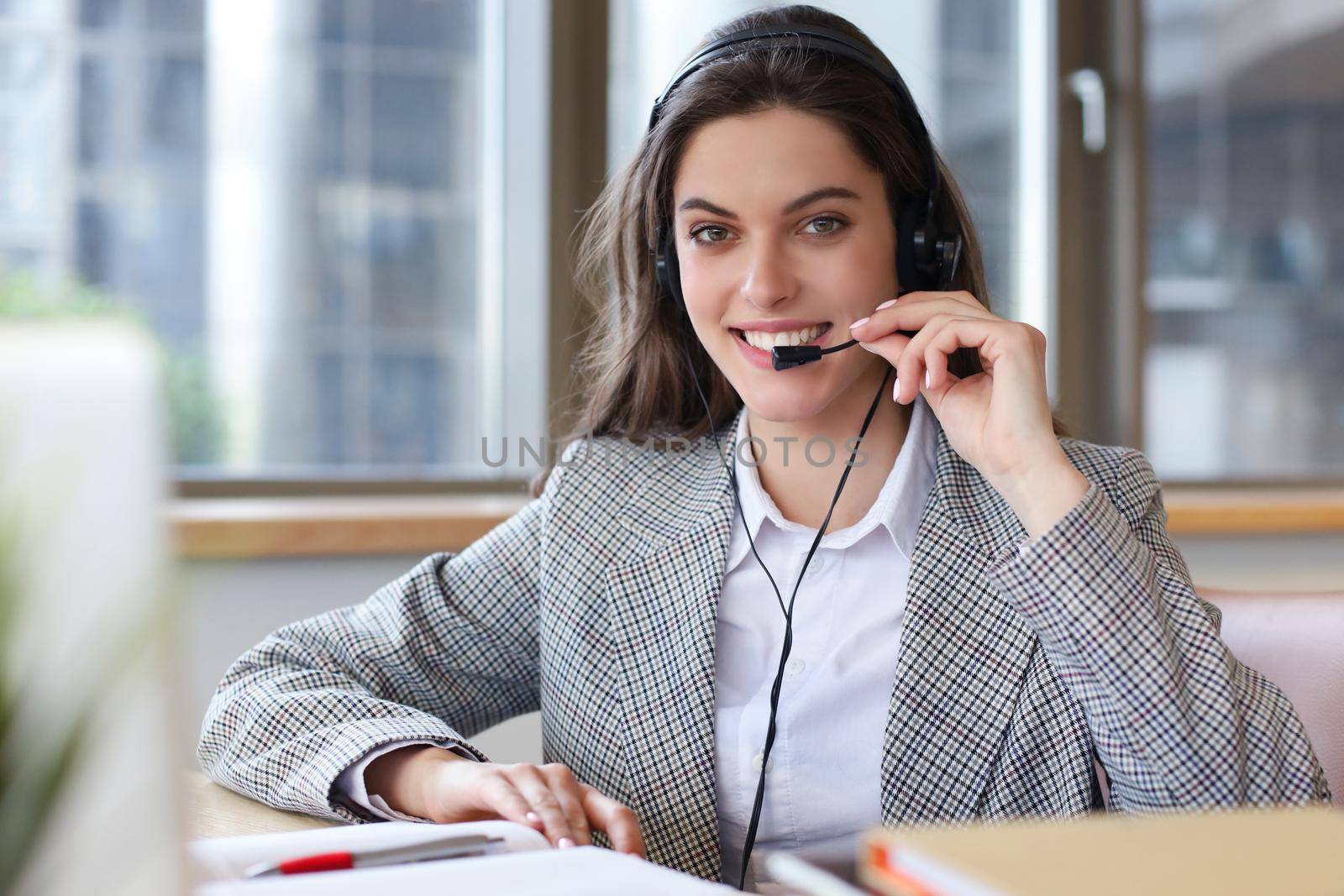 Woman customer support operator with headset and smiling
