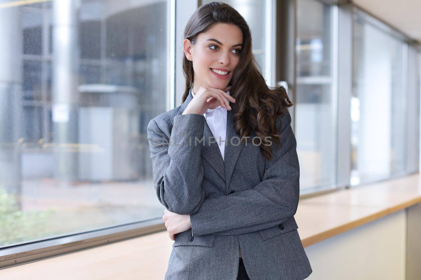 Attractive businesswoman standing near desk in the office