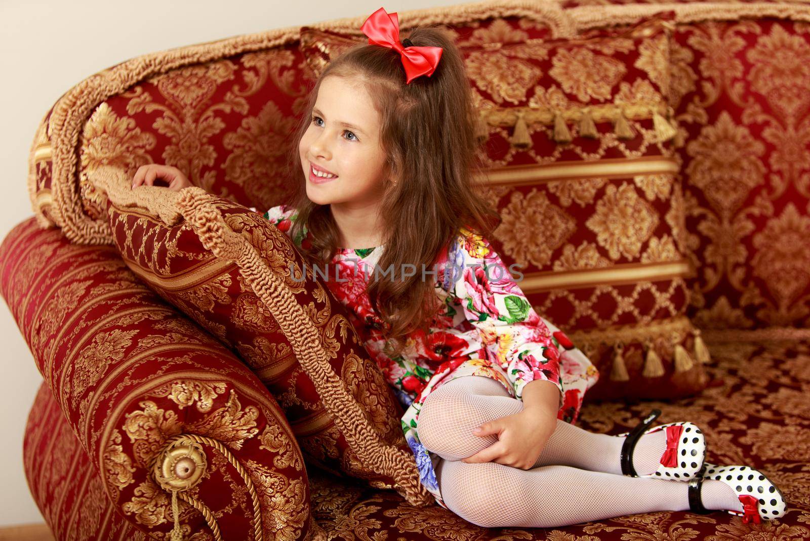 Girl sitting on the couch by kolesnikov_studio