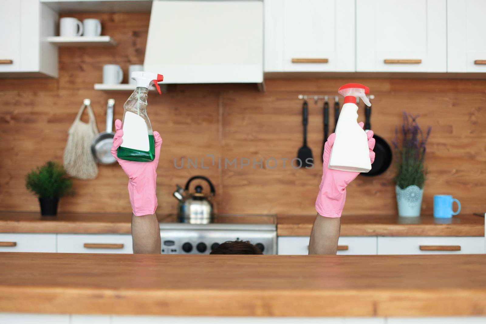 Single handsome man cleaning kitchen at home. by tsyhun