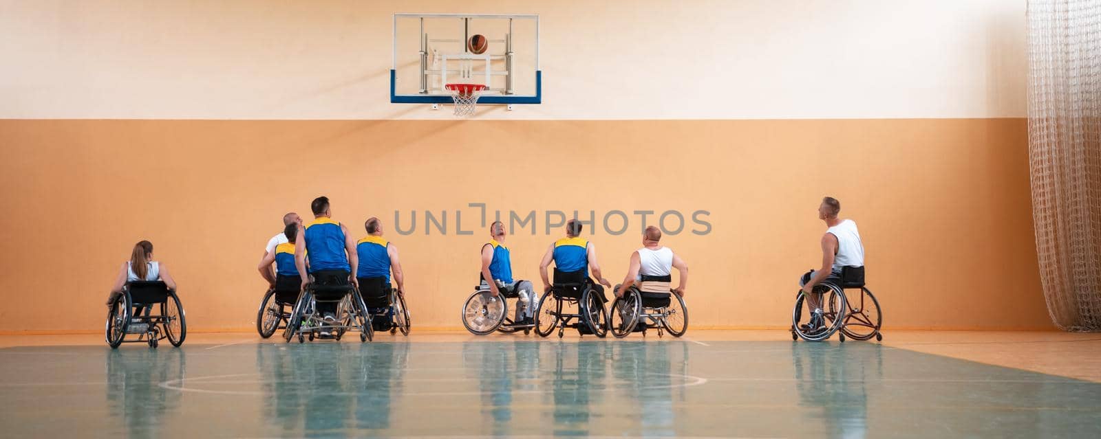 a photo of basketball teams with disabilities with the selector in the big hall before the start of the basketball game. Selective focus 