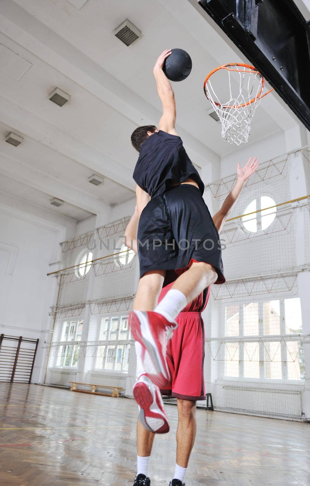 young and healthy people man have recreation and training exercise  while play basketball game at sport gym indoor hall