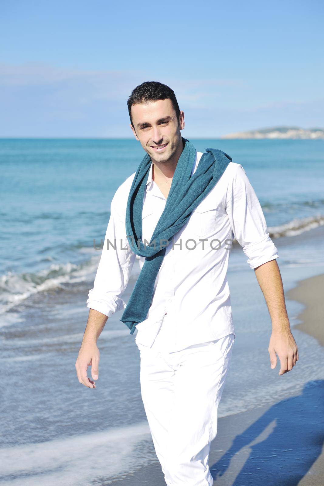 young man at beach by dotshock