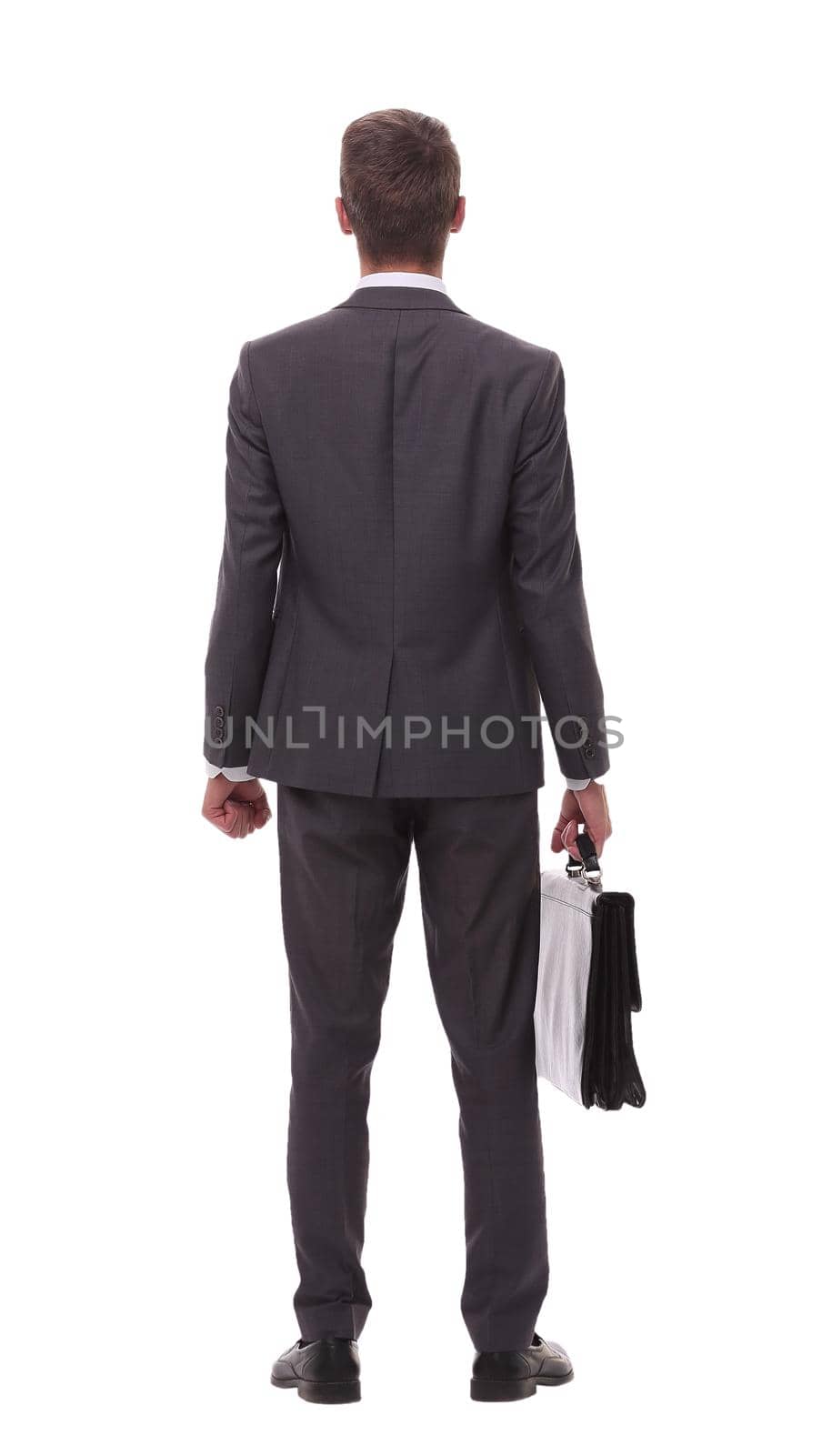 rear view. businessman with leather briefcase looking at copy space.isolated on white background