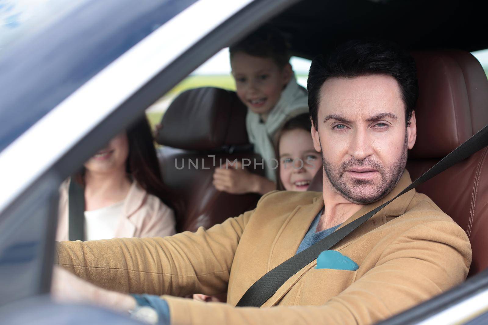 Family sitting in the car looking out windows by asdf