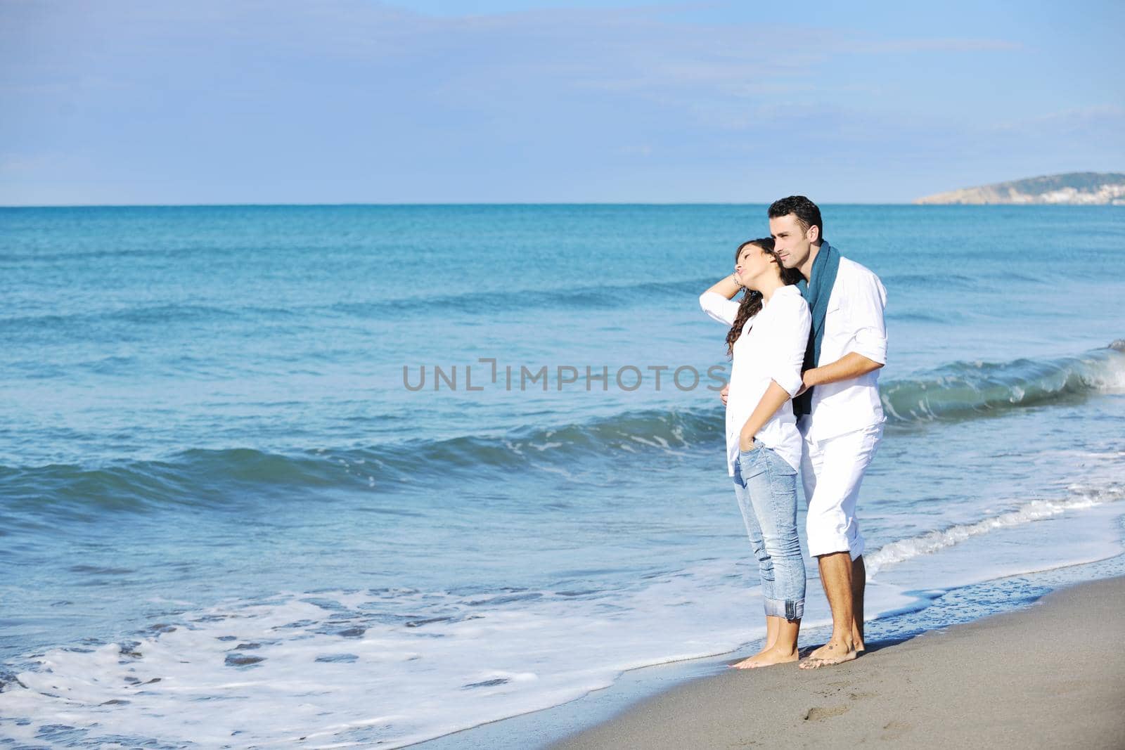 happy young couple in white clothing  have romantic recreation and   fun at beautiful beach on  vacations