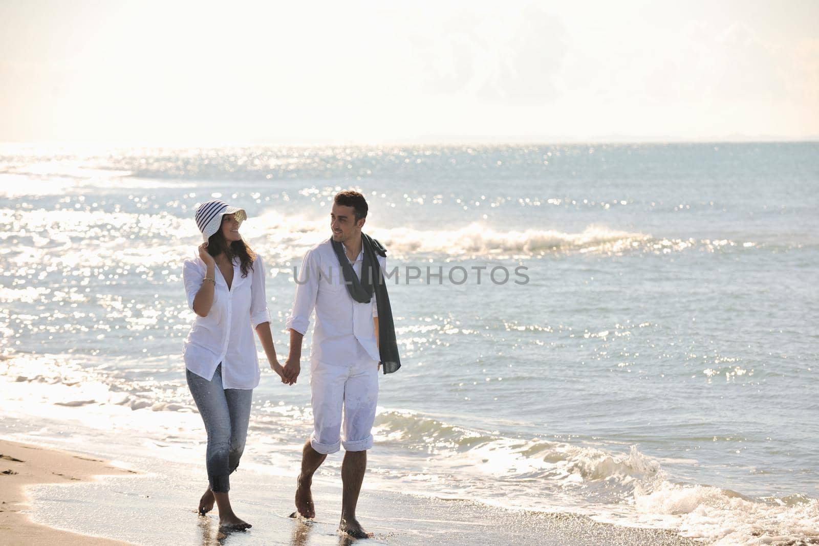 happy young couple in white clothing  have romantic recreation and   fun at beautiful beach on  vacations