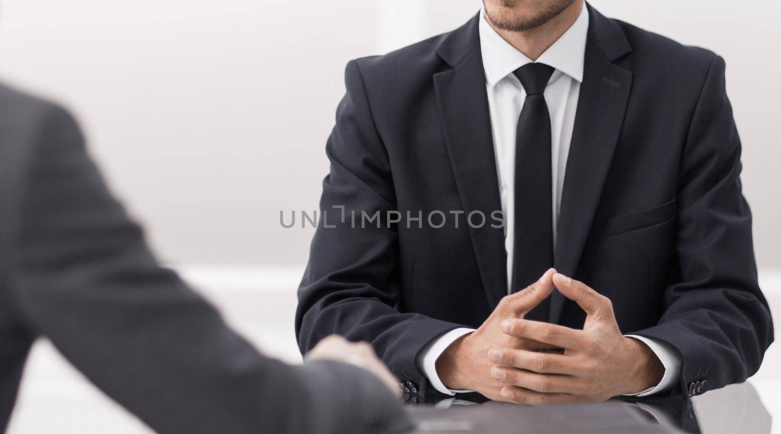 two business men talking sitting at a Desk.photo with copy space