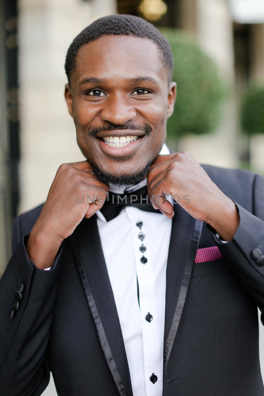 Portrait of afro american handsome man wearing suit and smiling. Concept of black businessman.