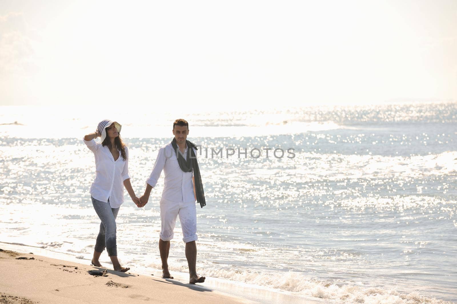 happy young couple in white clothing  have romantic recreation and   fun at beautiful beach on  vacations