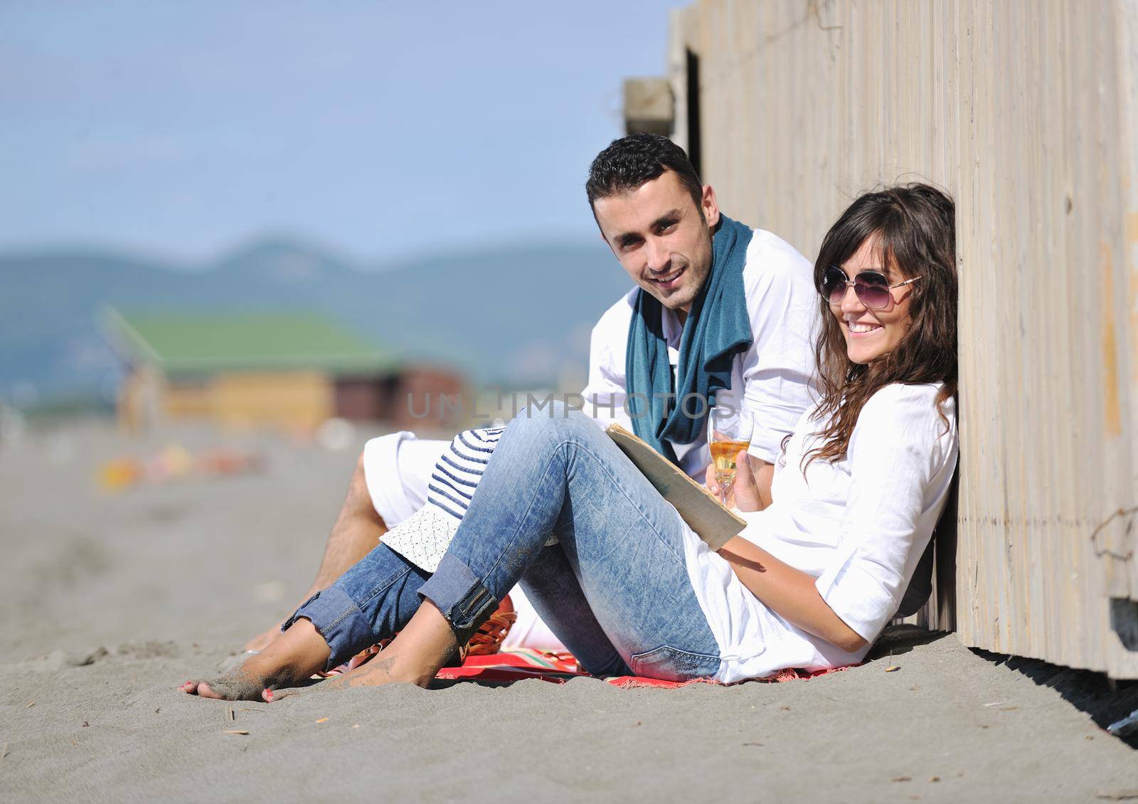 happy young couple enjoying  picnic on the beach and have good time on summer vacations