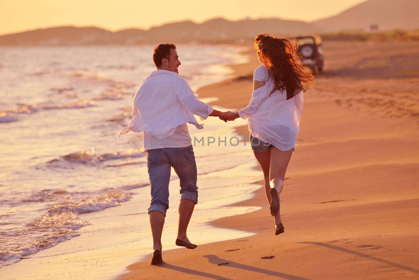 happy young romantic couple in love have fun on beautiful beach at beautiful summer day