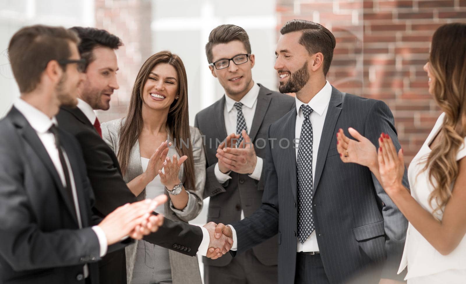 smiling business people shaking hands with each other by asdf
