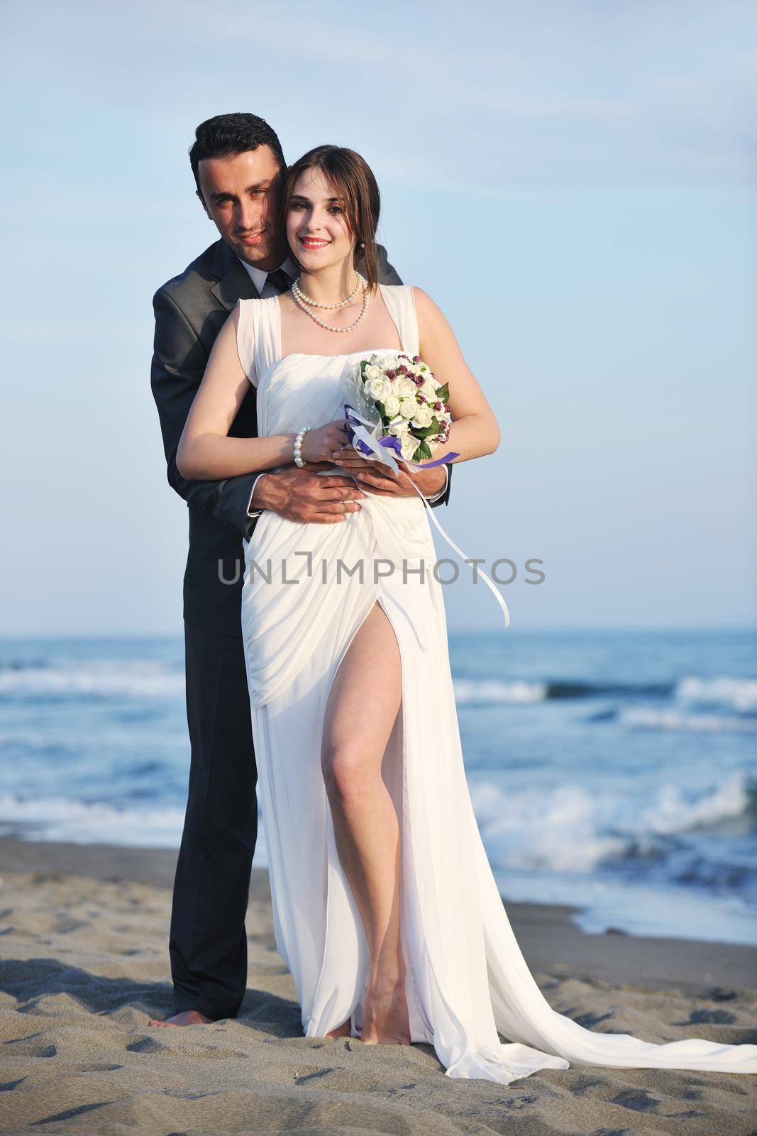 romantic beach wedding at sunset by dotshock