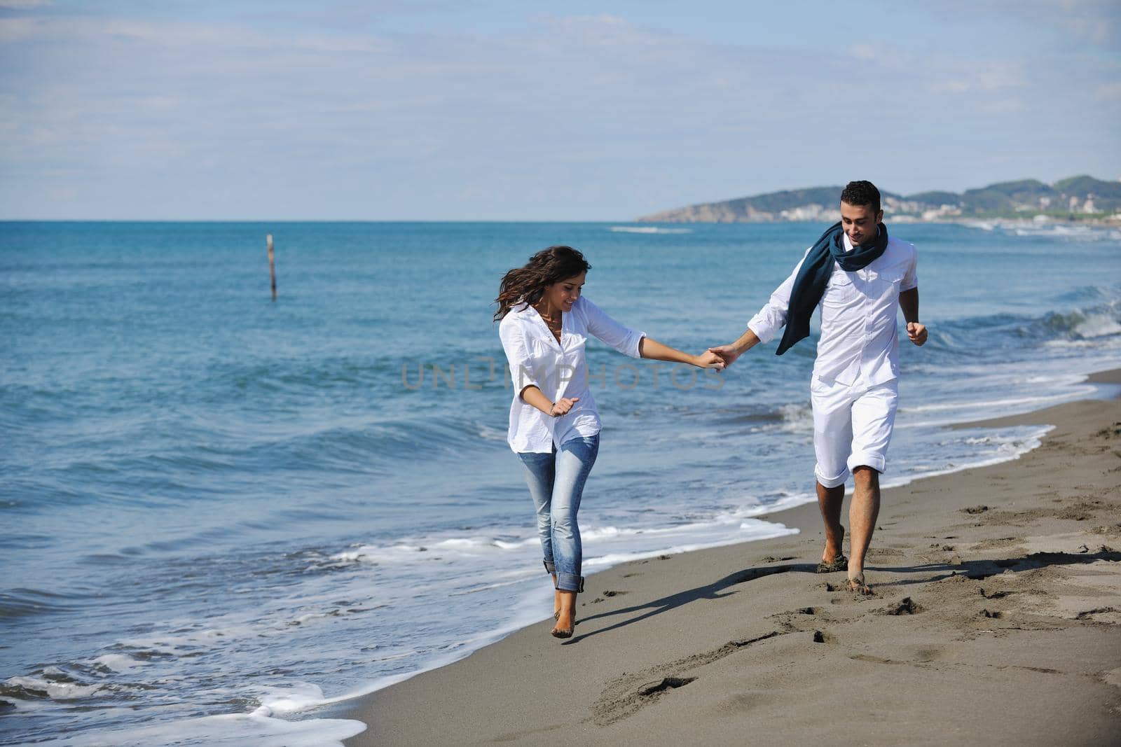 happy young couple in white clothing  have romantic recreation and   fun at beautiful beach on  vacations