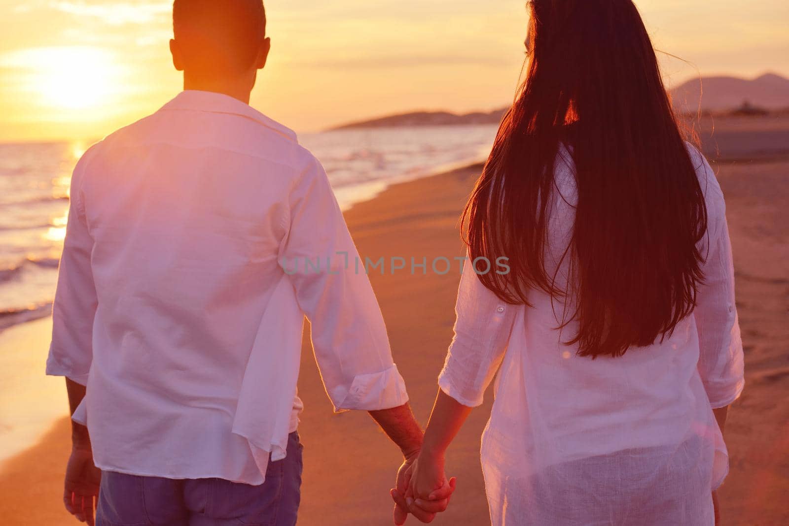 happy young romantic couple in love have fun on beautiful beach at beautiful summer day