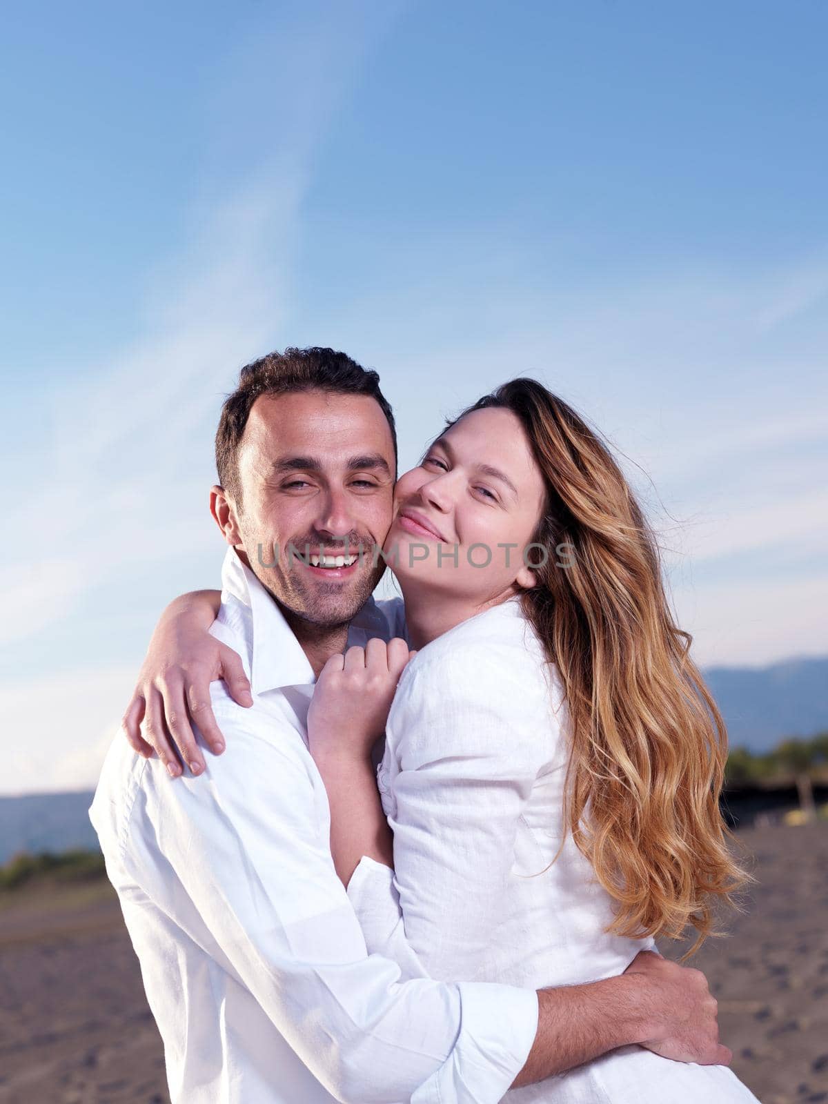 happy young romantic couple in love have fun on beautiful beach at beautiful summer day