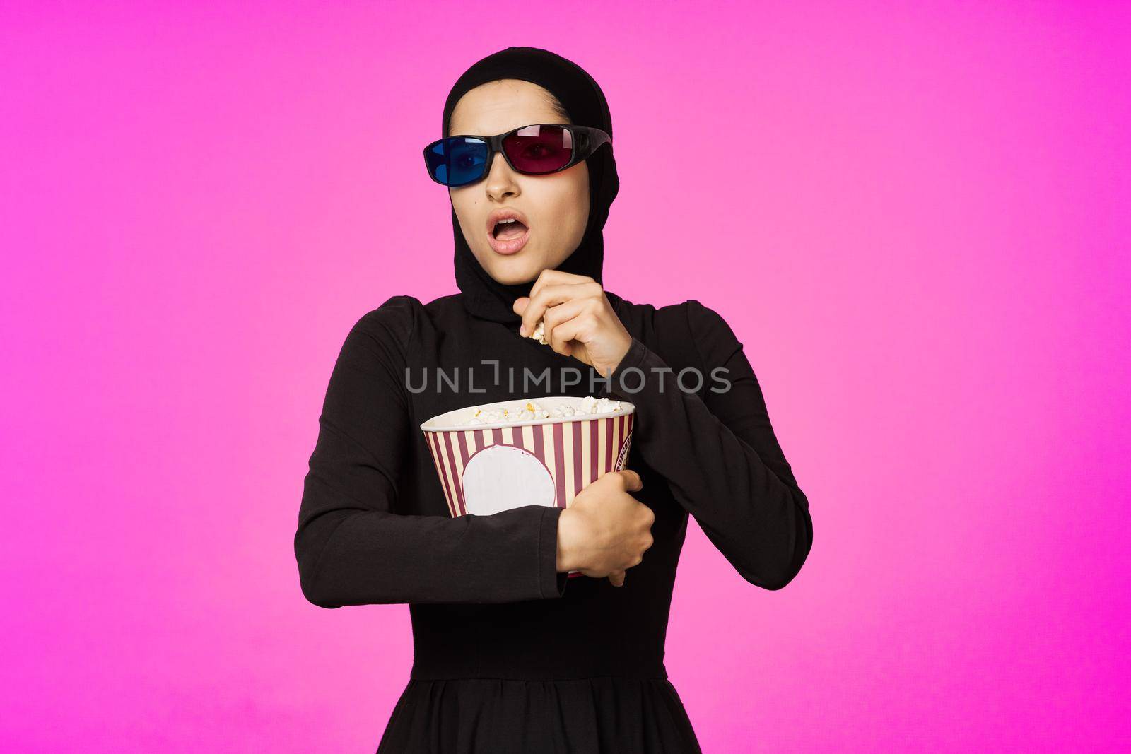 arab woman attractive look popcorn glasses movie watching studio lifestyle. High quality photo