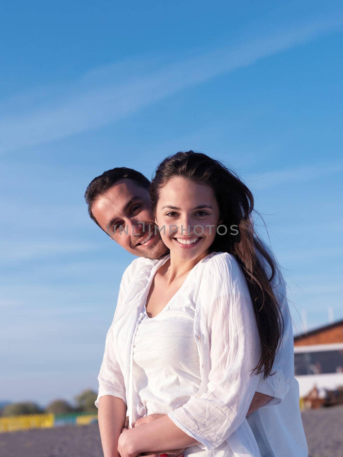 happy young romantic couple in love have fun on beautiful beach at beautiful summer day