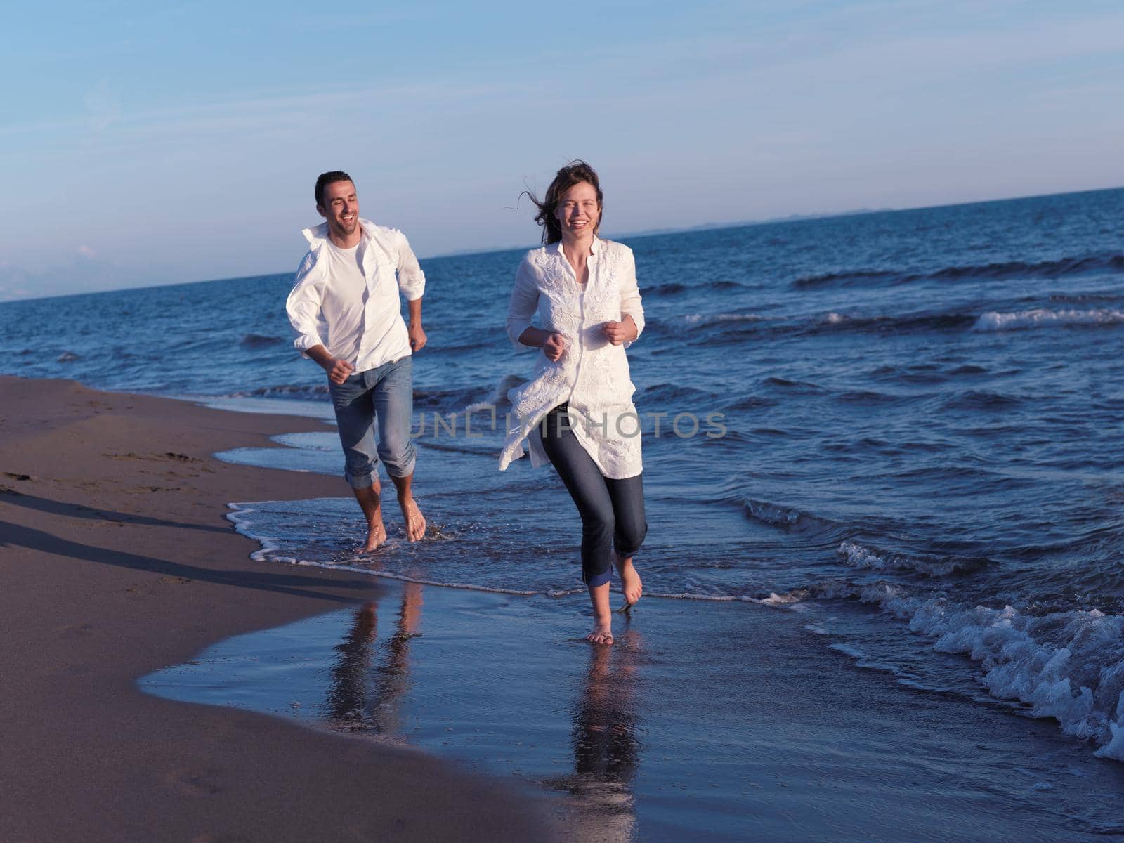 young couple  on beach have fun by dotshock