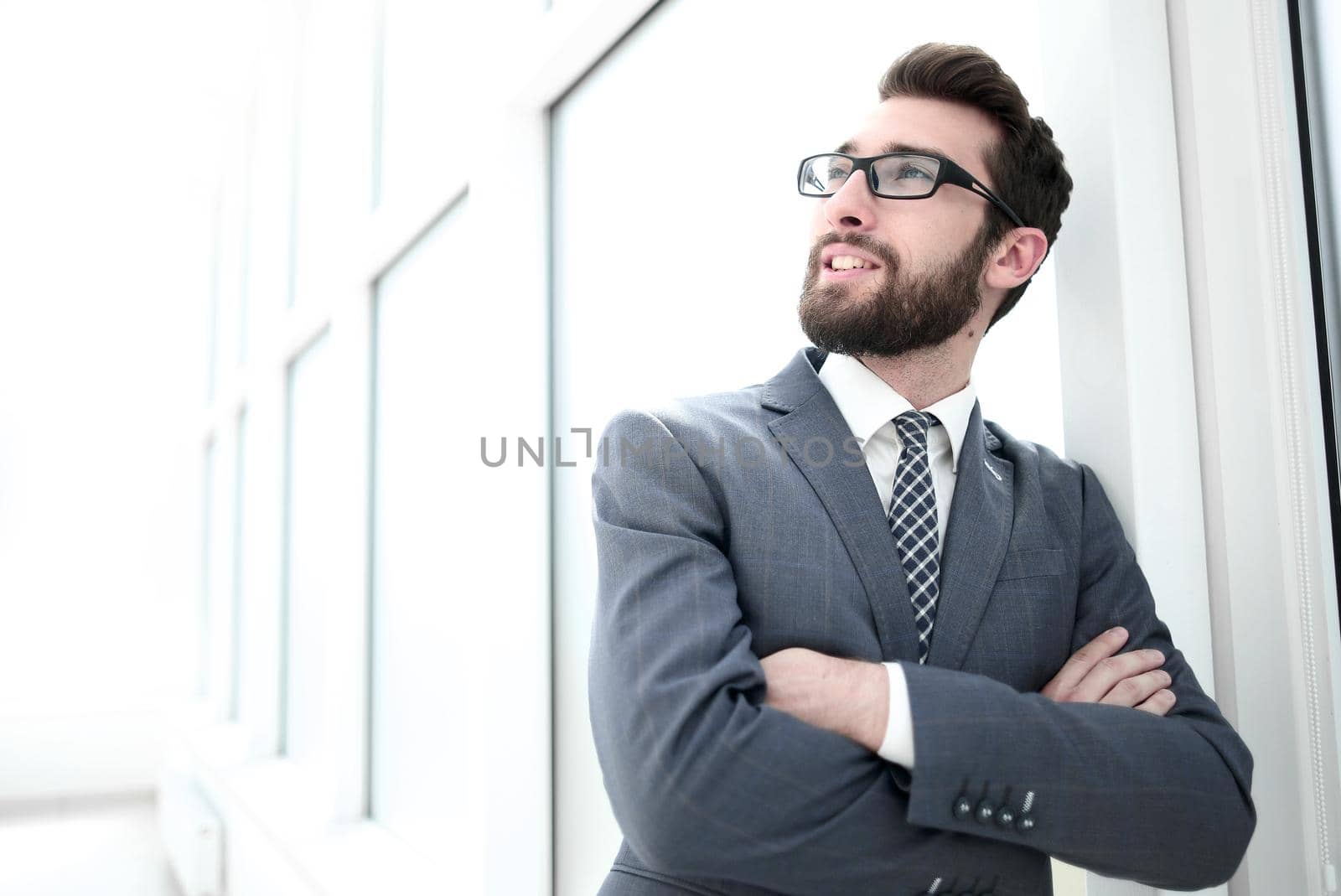 close up.portrait of a confident businessman standing in a bright office.