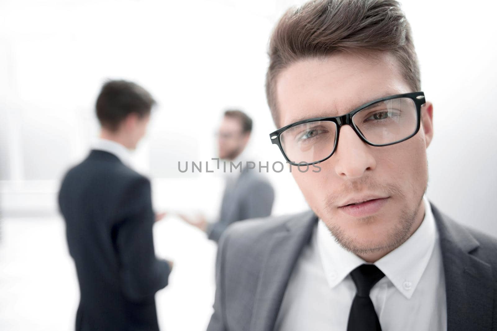 close up.confident young businessman in the office background