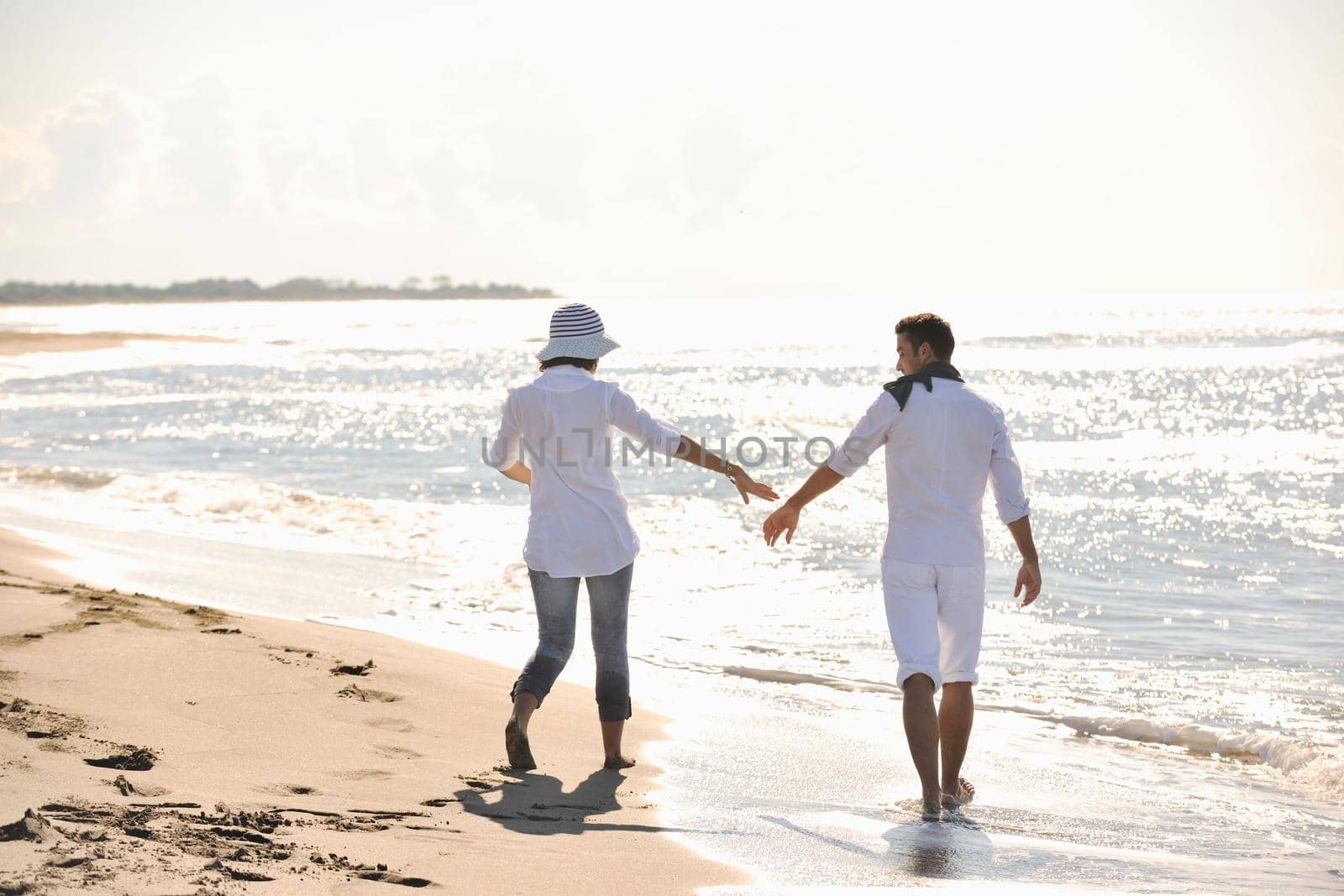 happy young couple in white clothing  have romantic recreation and   fun at beautiful beach on  vacations