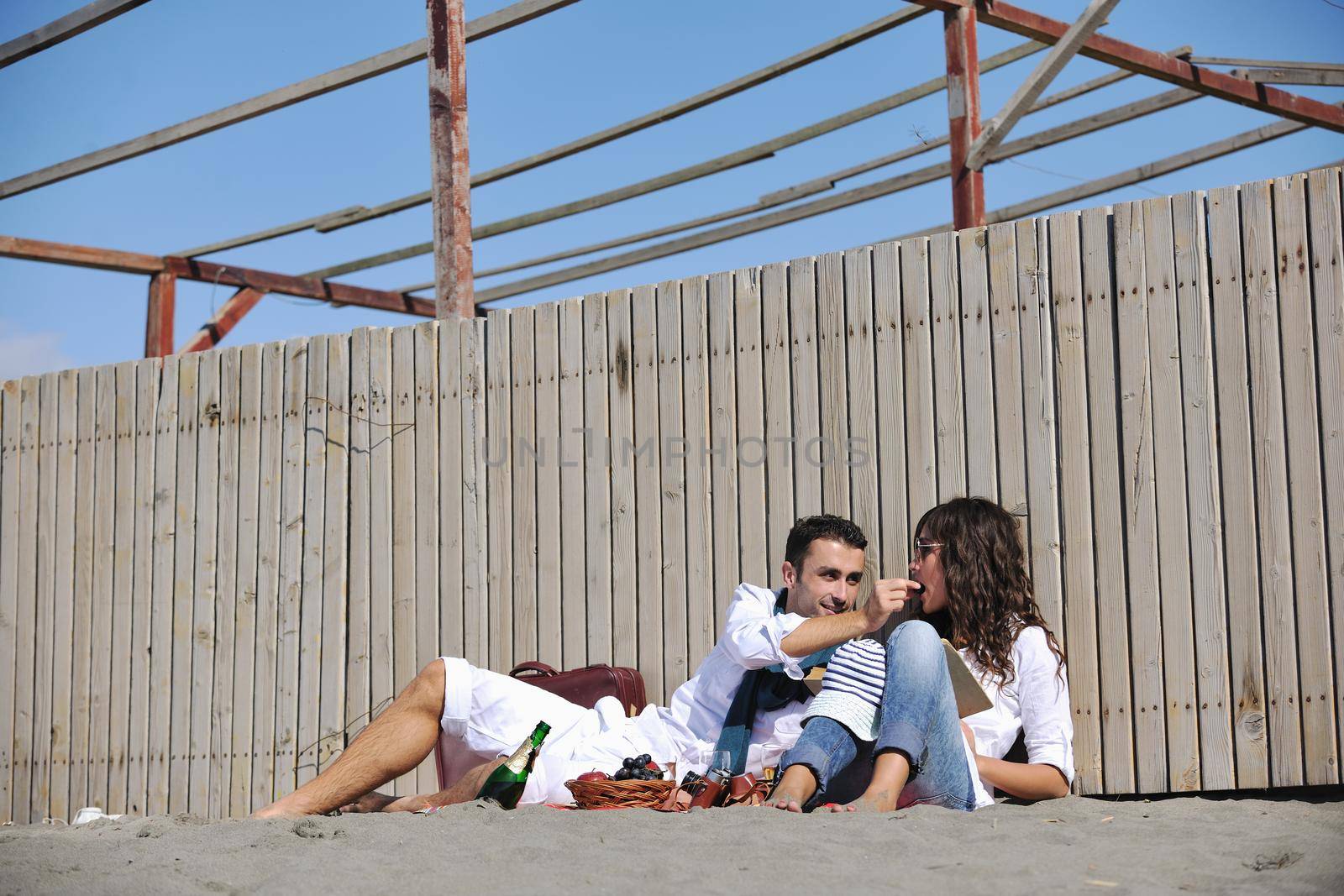 happy young couple enjoying  picnic on the beach and have good time on summer vacations