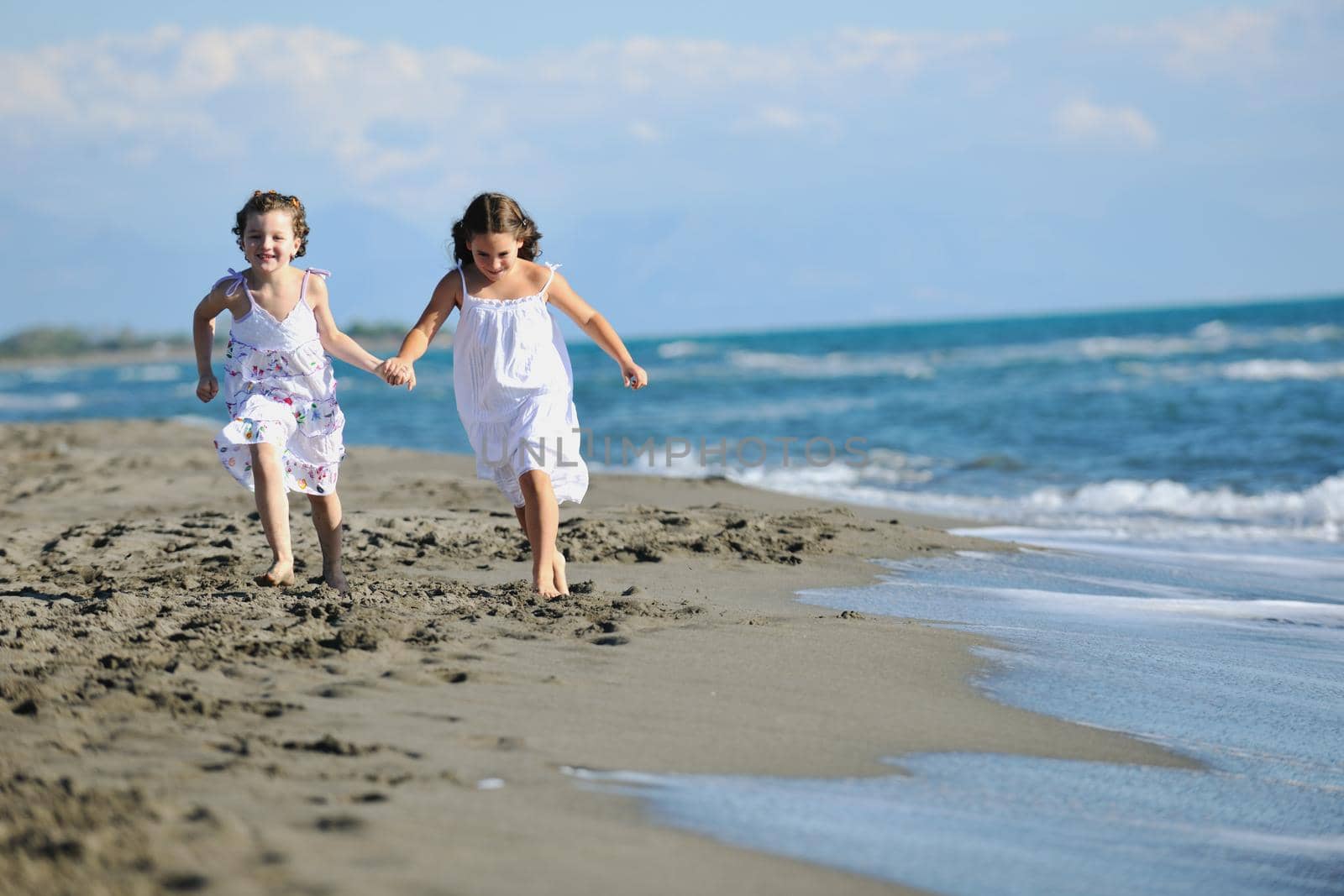 cute little girls running on beach by dotshock