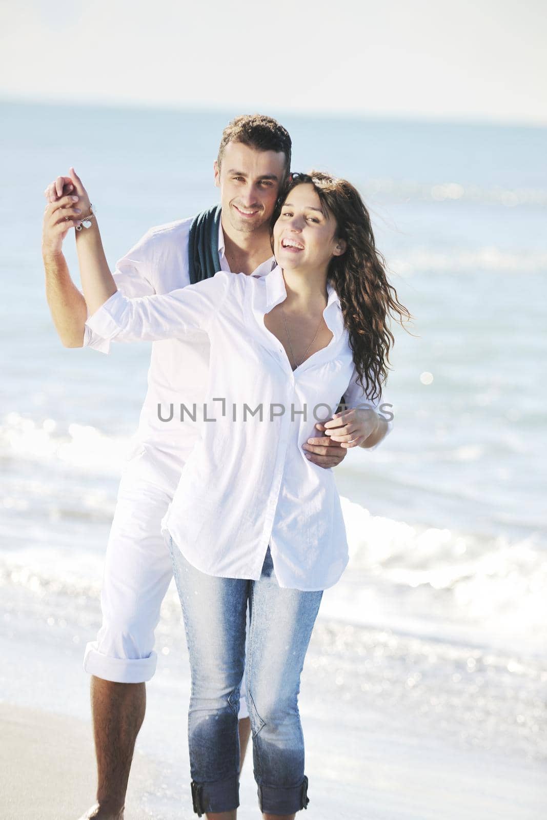 happy young couple in white clothing  have romantic recreation and   fun at beautiful beach on  vacations