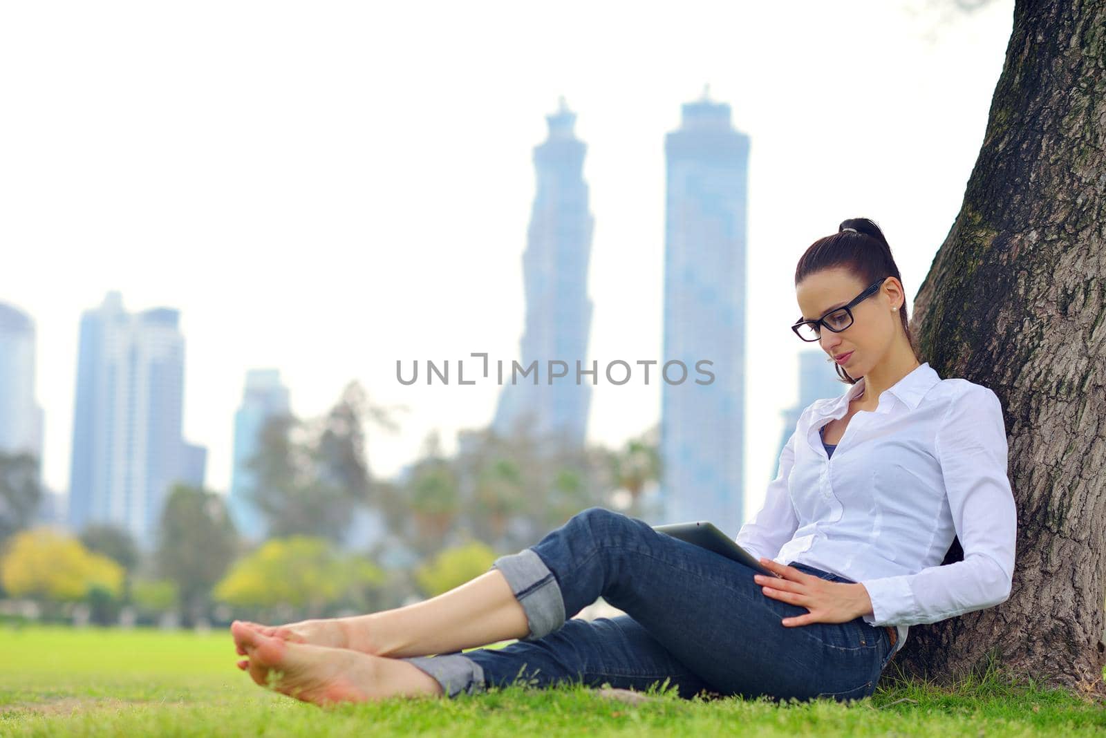 Beautiful young student  woman study with tablet in park