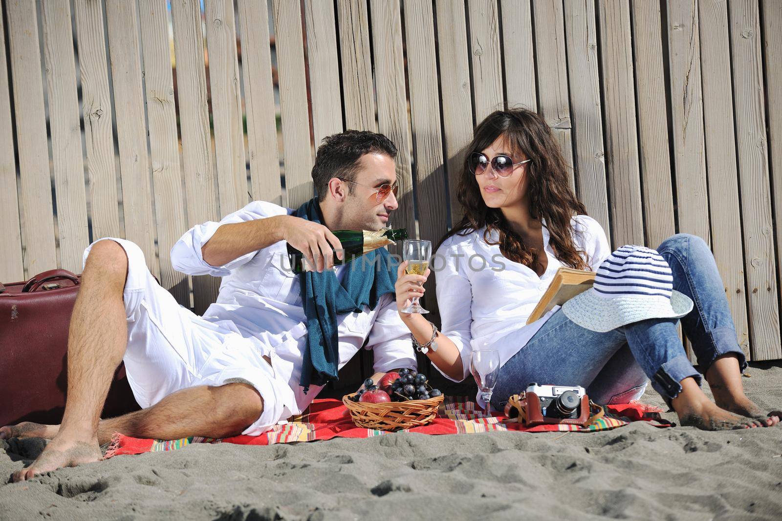 happy young couple enjoying  picnic on the beach and have good time on summer vacations