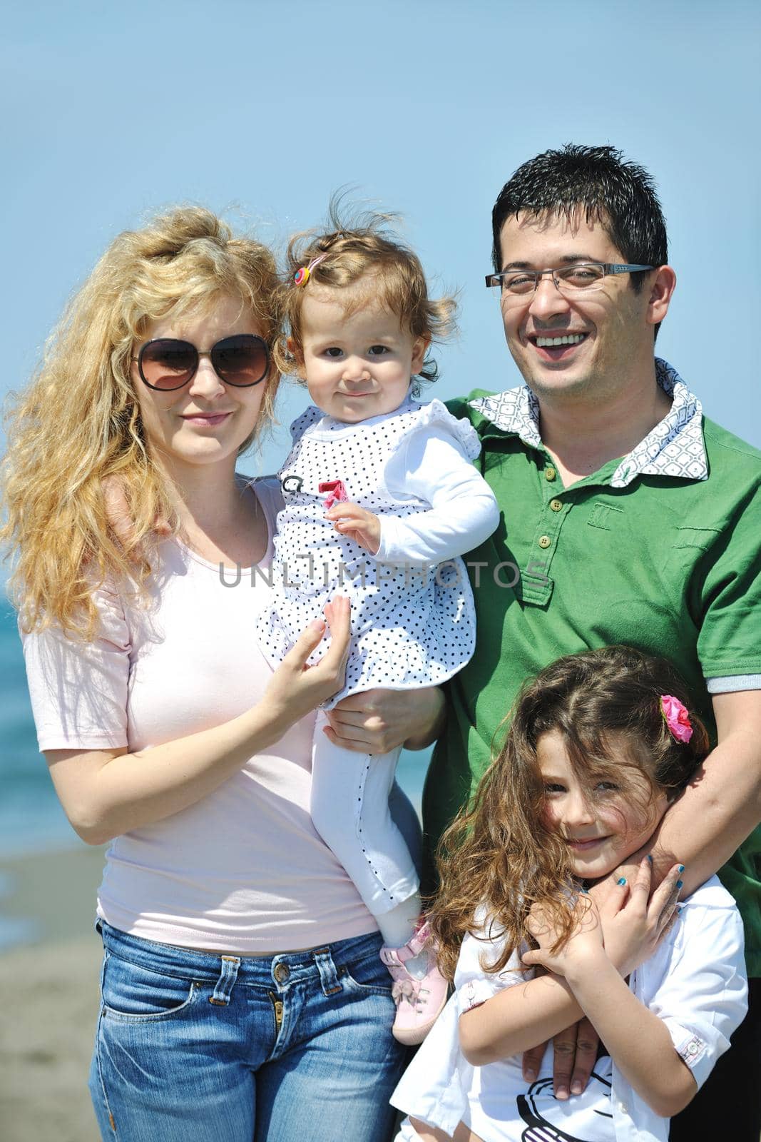 happy young family have fun and live healthy lifestyle on beach