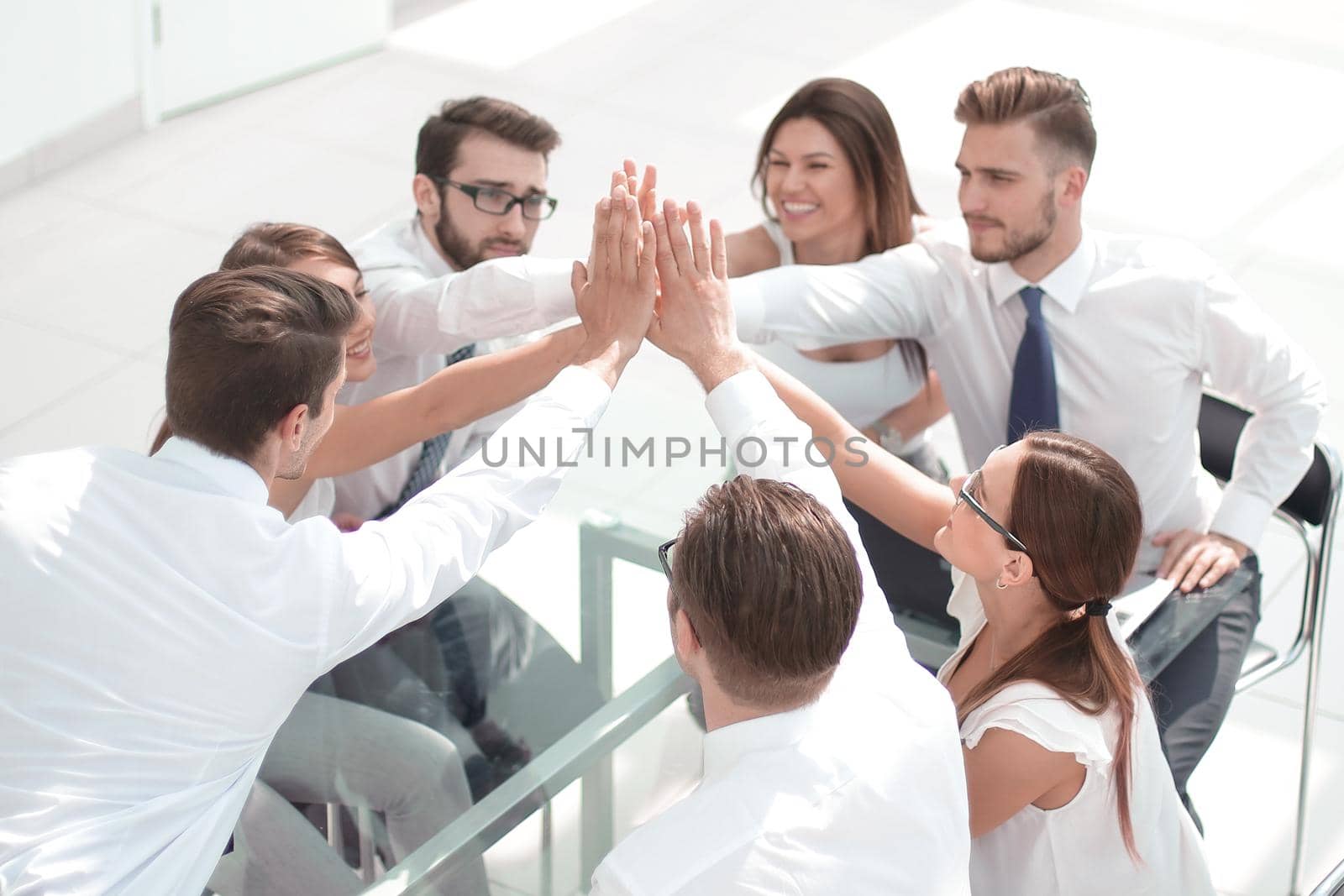 successful business team giving each other a high five by asdf