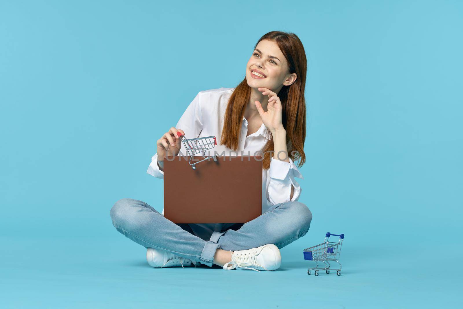 woman with laptop learning internet online education blue background. High quality photo