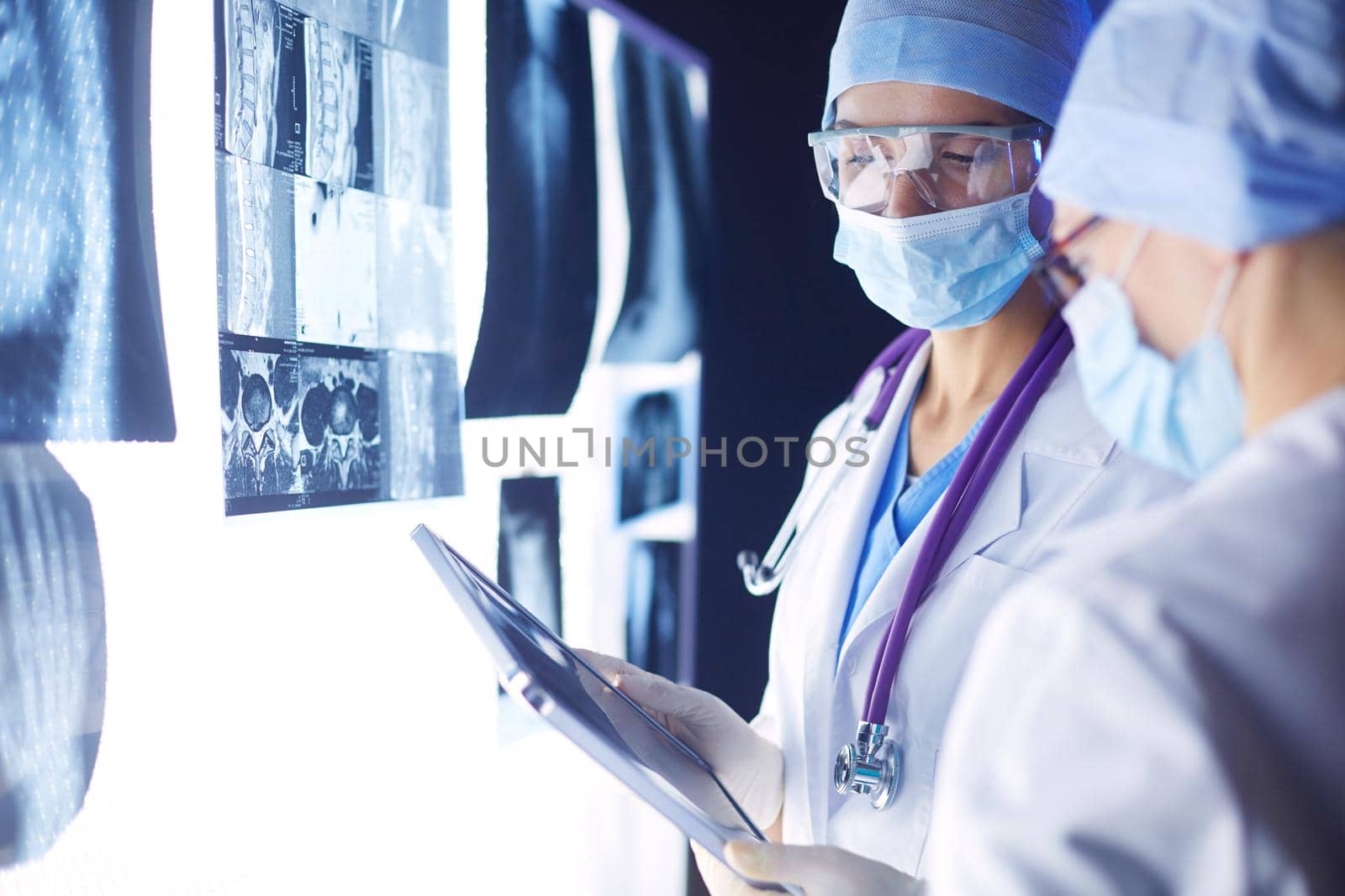 Two female women medical doctors looking at x-rays in a hospital