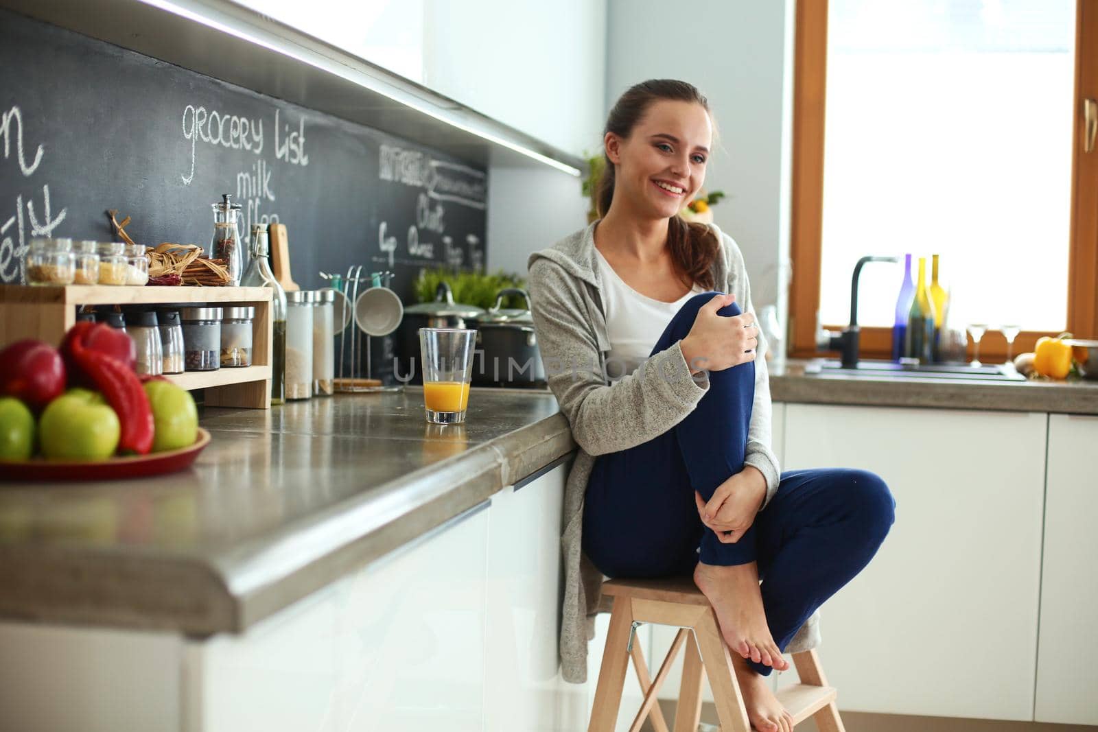 Young woman sitting a table in the kitchen