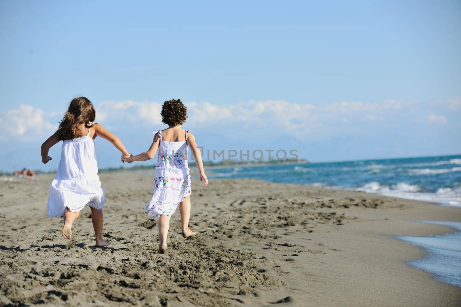 cute little girls running on beach by dotshock