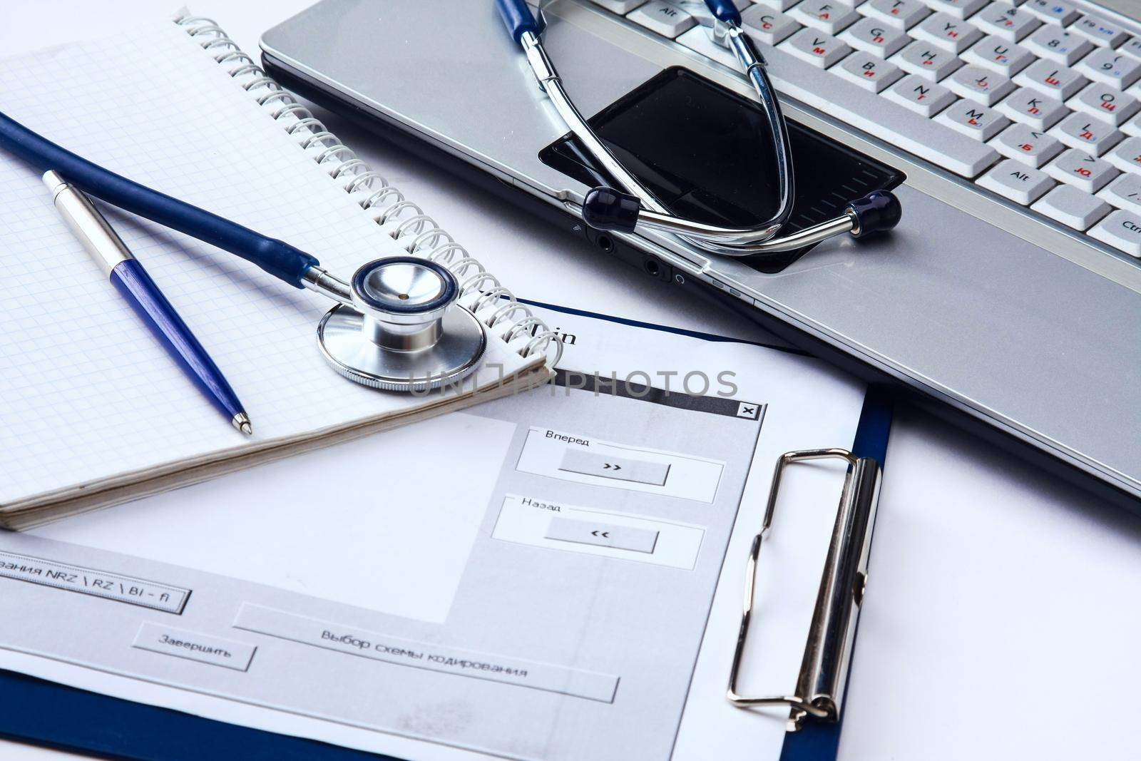 Stethoscope with clipboard and laptop on the desk by lenetstan