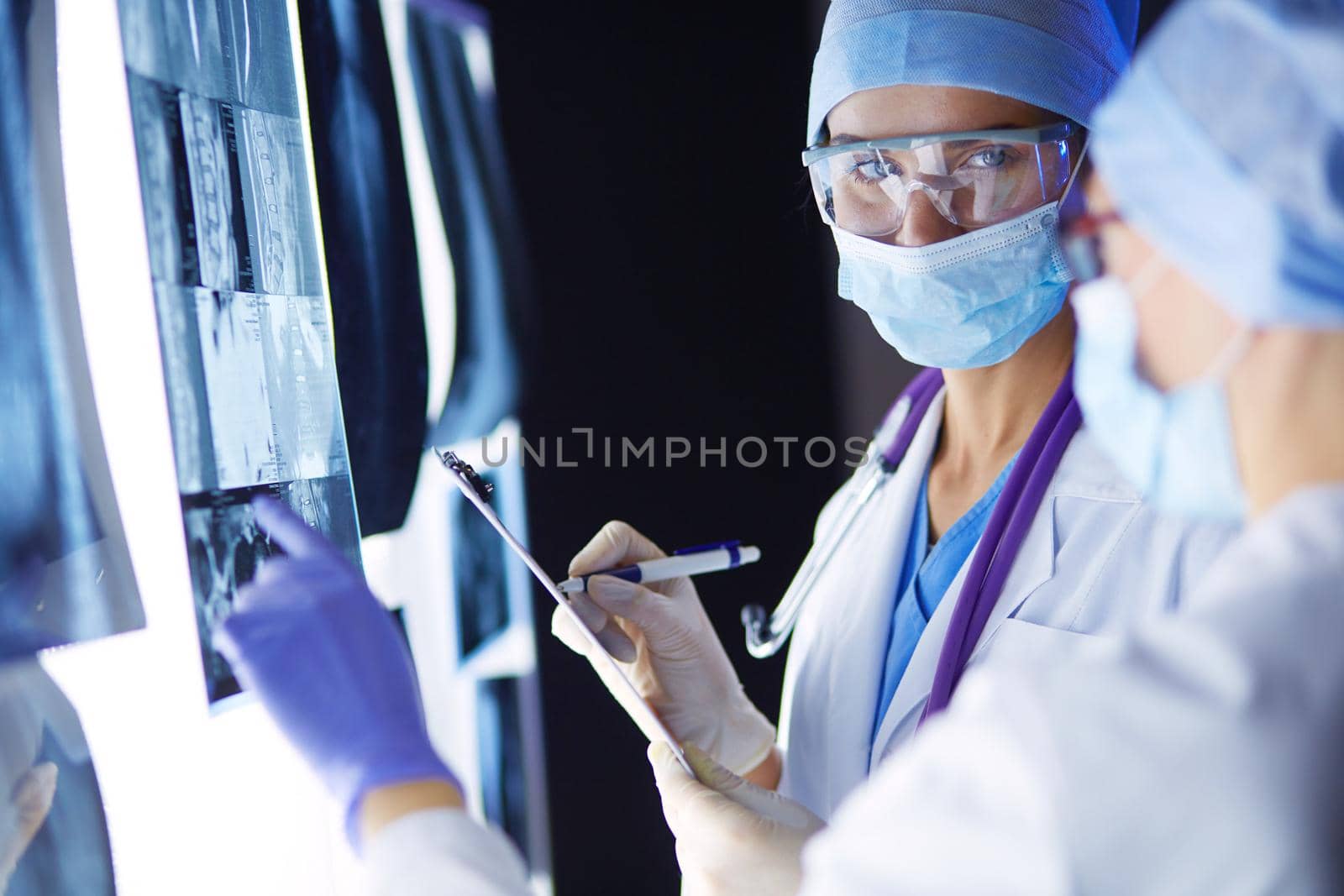 Two female women medical doctors looking at x-rays in a hospital