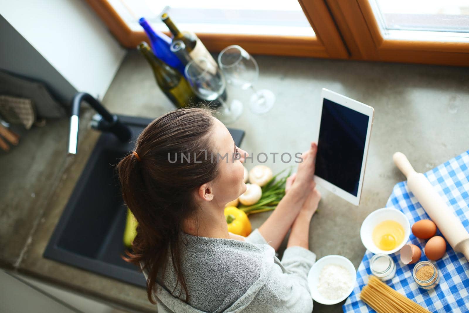 Woman baking at home following recipe on a tablet by lenetstan